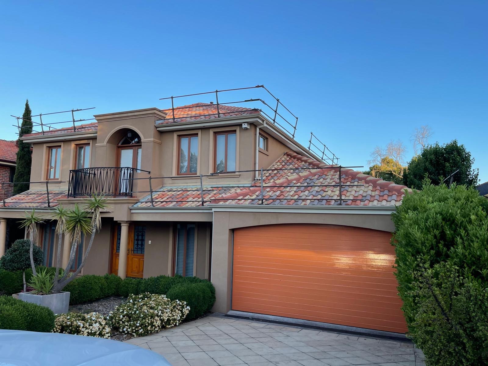 Completed tile roof restoration at golden hour