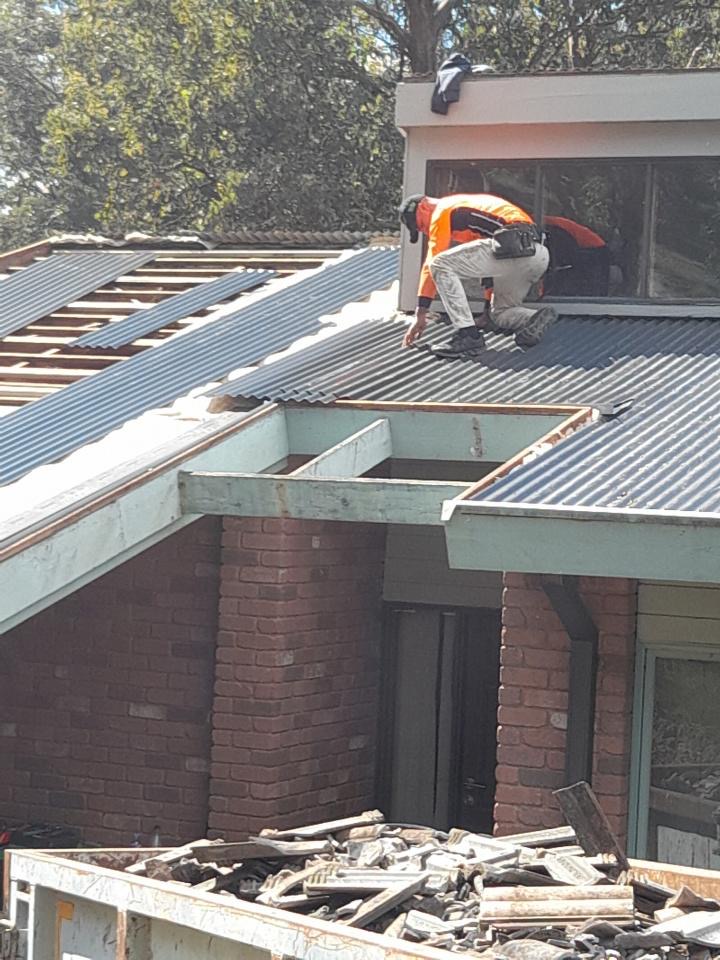 Roofer laying new Colorbond sheets